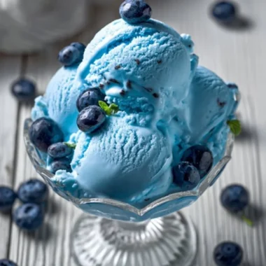A bowl of homemade blue moon ice cream topped with sprinkles.