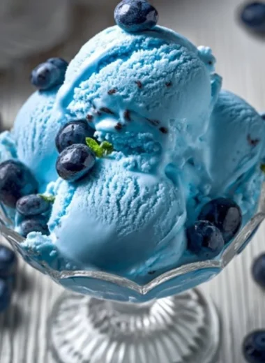 A bowl of homemade blue moon ice cream topped with sprinkles.