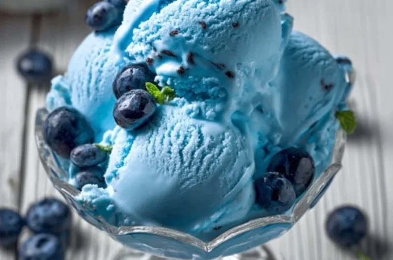 A bowl of homemade blue moon ice cream topped with sprinkles.