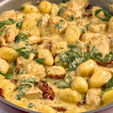 Bowl of creamy chicken gnocchi with herbs and vegetables
