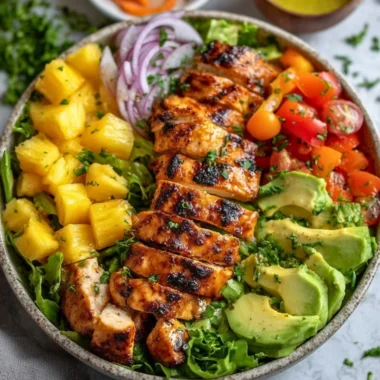 A bowl of Hawaiian Chicken Salad with colorful vegetables and grilled chicken