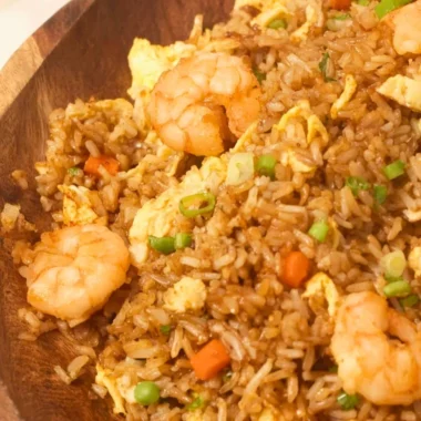 Plate of homemade Chinese shrimp fried rice garnished with green onions.