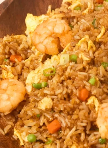 Plate of homemade Chinese shrimp fried rice garnished with green onions.