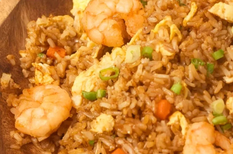 Plate of homemade Chinese shrimp fried rice garnished with green onions.