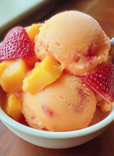 A delicious bowl of homemade Mango Strawberry Sorbet served in a vibrant dish.