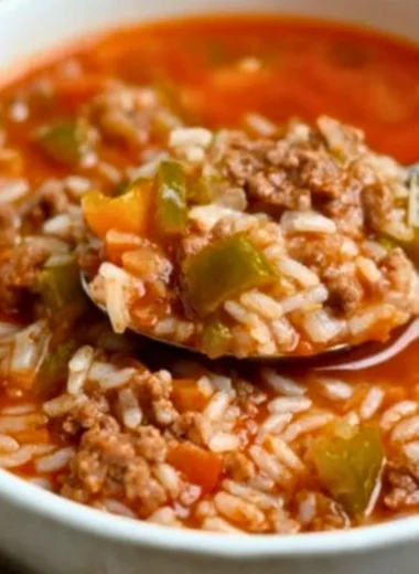 A bowl of flavorful stuffed pepper soup with colorful bell peppers and spices