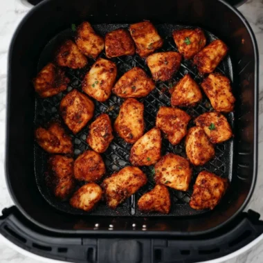 Crispy air fryer chicken bites served in a bowl with dipping sauce