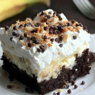 Delicious Chocolate Banana Poke Cake topped with chocolate and banana slices