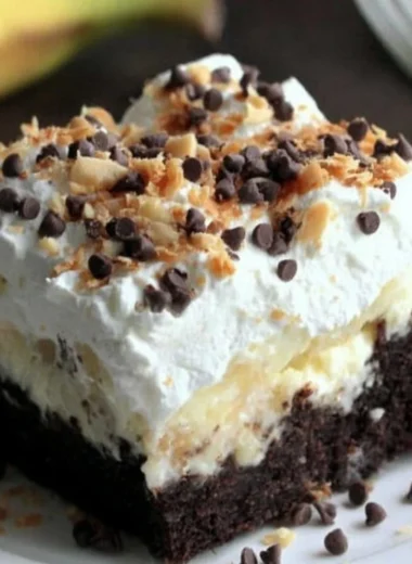 Delicious Chocolate Banana Poke Cake topped with chocolate and banana slices