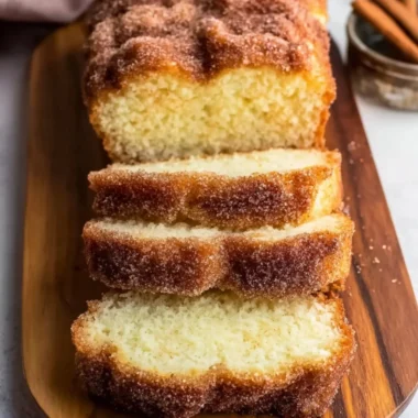 Sliced cinnamon sugar donut bread on a wooden table