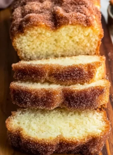 Sliced cinnamon sugar donut bread on a wooden table