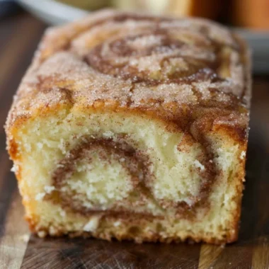 Freshly baked Cinnamon Swirl Donut Bread with a golden, cinnamon-sugar topping