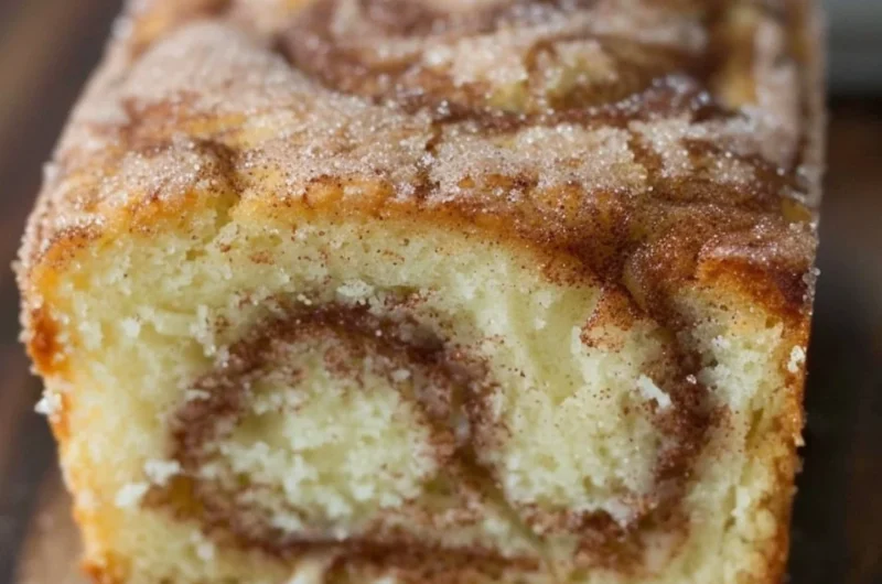 Freshly baked Cinnamon Swirl Donut Bread with a golden, cinnamon-sugar topping