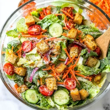 Fresh classic house salad with mixed greens, tomatoes, and cucumbers.