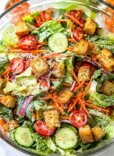 Fresh classic house salad with mixed greens, tomatoes, and cucumbers.