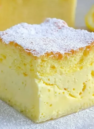 Cozy Magic Lemon Custard Cake with a slice on a plate