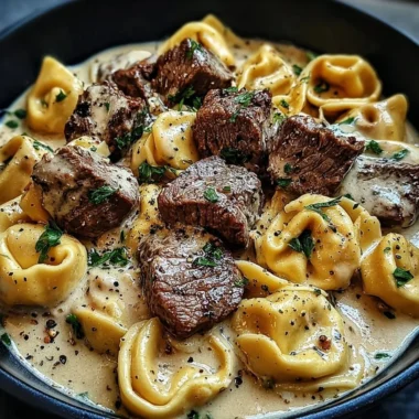 Cracked garlic steak tortellini served in creamy sauce with herbs