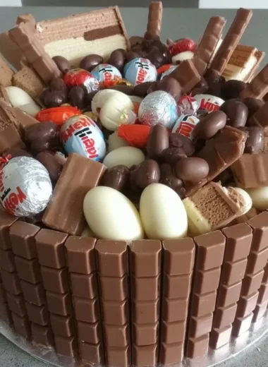 Decadent creamy Kinder Chocolate Cake topped with chocolate shavings.