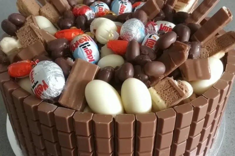 Decadent creamy Kinder Chocolate Cake topped with chocolate shavings.