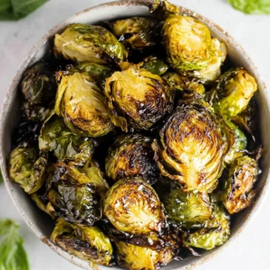 Crispy oven roasted brussel sprouts with balsamic glaze in a serving dish