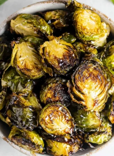 Crispy oven roasted brussel sprouts with balsamic glaze in a serving dish