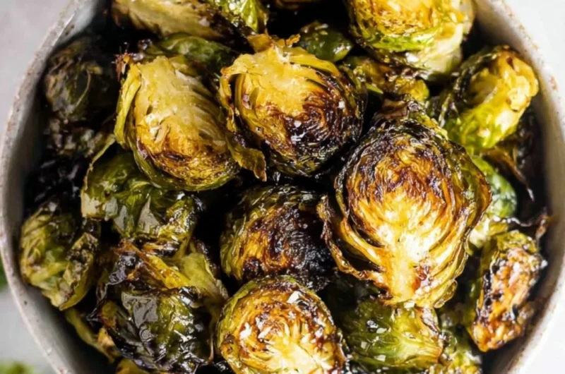 Crispy oven roasted brussel sprouts with balsamic glaze in a serving dish