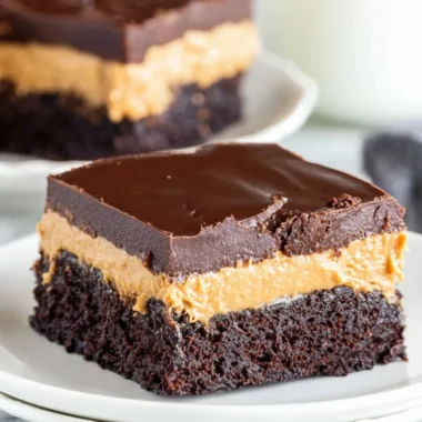 Layered peanut butter brownies topped with chocolate drizzle