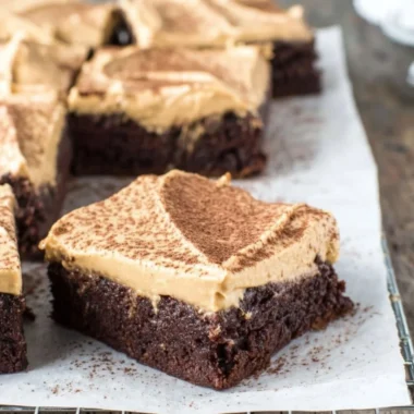 Mocha brownies with cafe latte frosting on a white plate