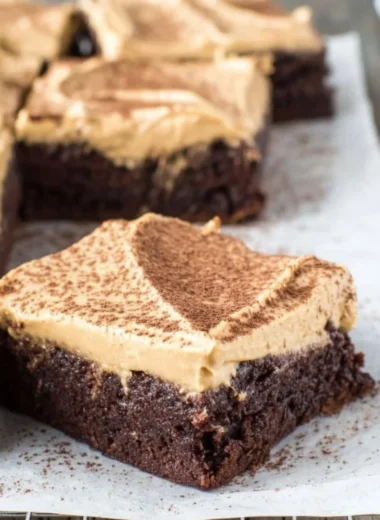 Mocha brownies with cafe latte frosting on a white plate