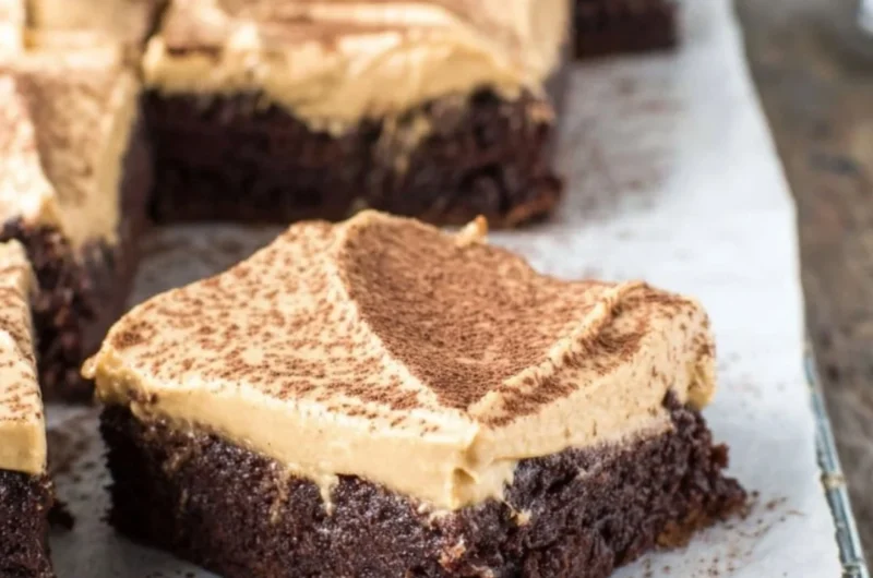 Mocha brownies with cafe latte frosting on a white plate