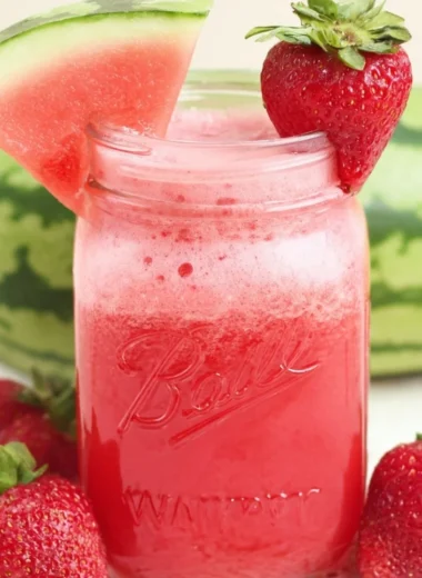 A refreshing glass of Strawberry Watermelon Cucumber Juice garnished with fresh mint.