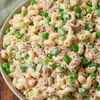 A vibrant bowl of tuna pasta salad with veggies and dressing