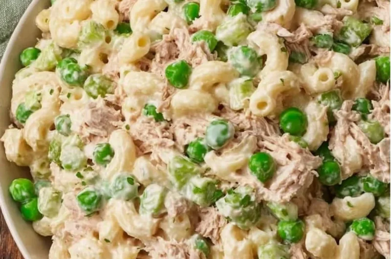 A vibrant bowl of tuna pasta salad with veggies and dressing