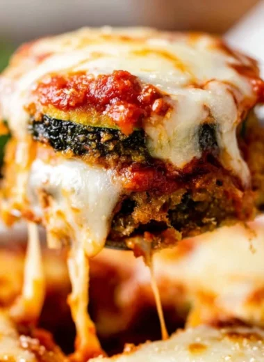 Baked Zucchini Parmesan with melted cheese and herbs