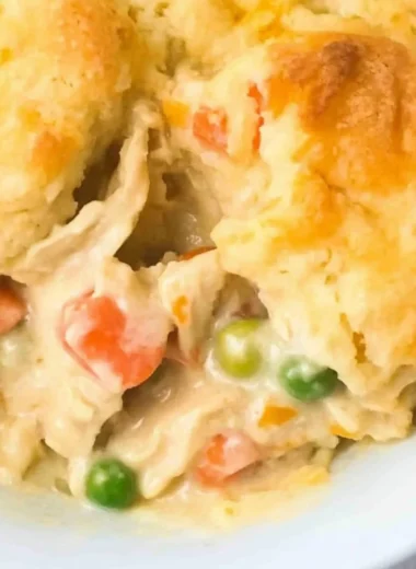 Delicious homemade Chicken Cobbler with fresh ingredients on a rustic table.