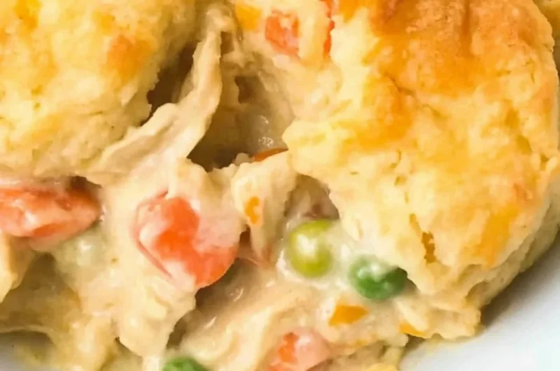 Delicious homemade Chicken Cobbler with fresh ingredients on a rustic table.