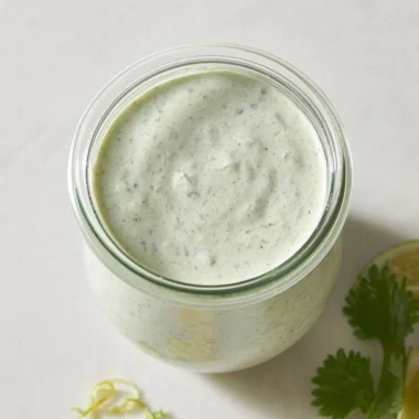 Cilantro lime cream sauce served in a bowl with fresh herbs