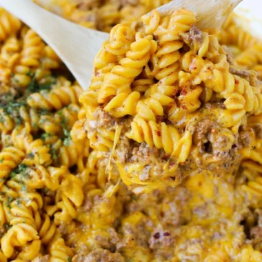 Creamy beef rotini pasta dish served in a bowl garnished with herbs
