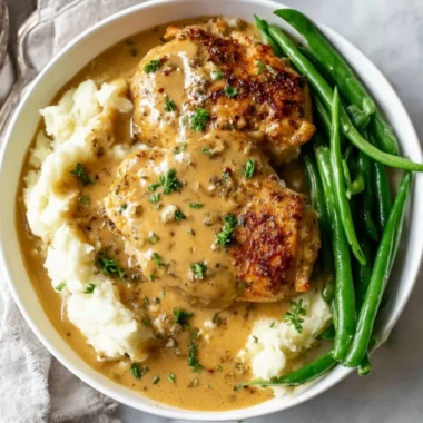 Creamy garlic chicken dish served on a plate with herbs and sides