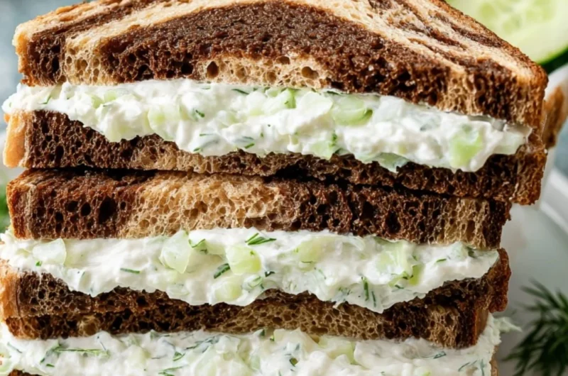 Refreshing cucumber sandwiches on a plate, ideal for parties and picnics.