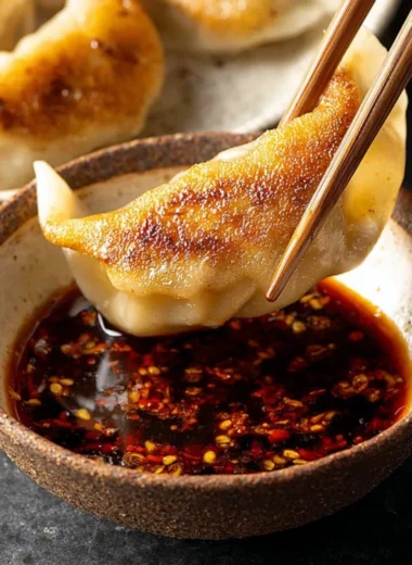 Homemade dumpling dipping sauce served in a small bowl.
