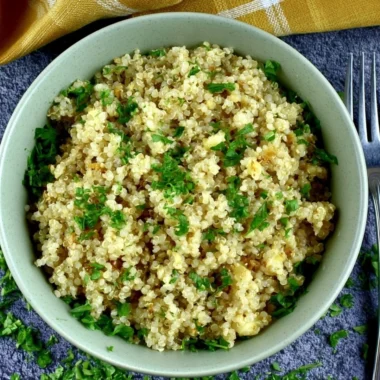 Delicious garlic butter quinoa served in a bowl, garnished with herbs.