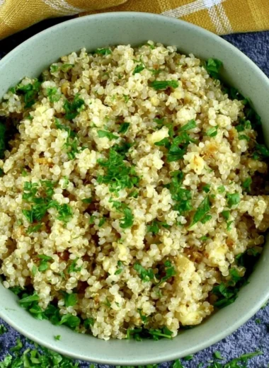 Delicious garlic butter quinoa served in a bowl, garnished with herbs.