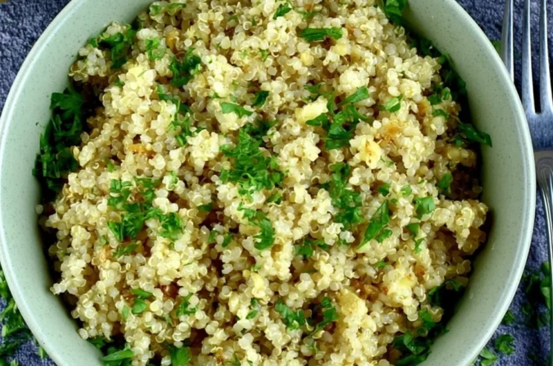Delicious garlic butter quinoa served in a bowl, garnished with herbs.