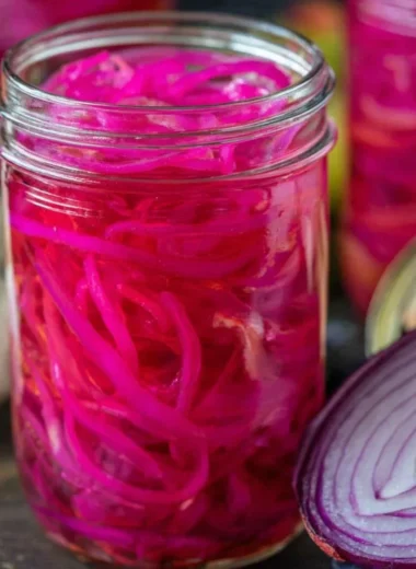 Quick pickled red onions in a jar, ready to enhance any meal.