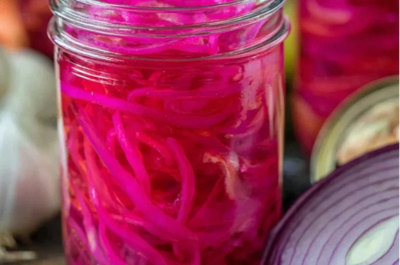 Quick pickled red onions in a jar, ready to enhance any meal.