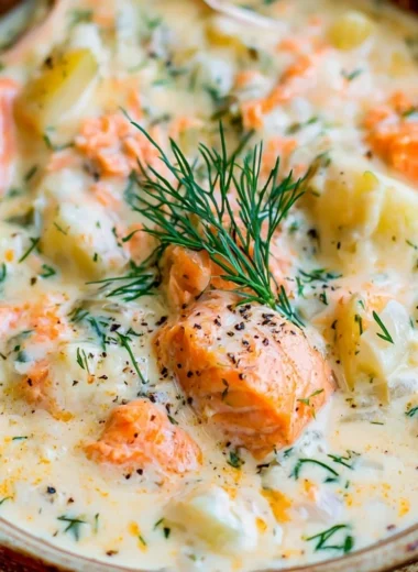 Bowl of creamy salmon chowder soup garnished with herbs