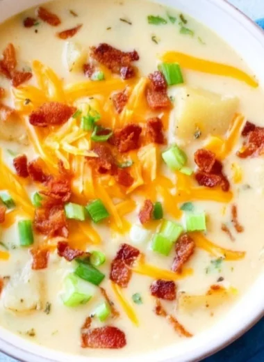 Bowl of creamy Slow Cooker Potato Soup garnished with green onions.