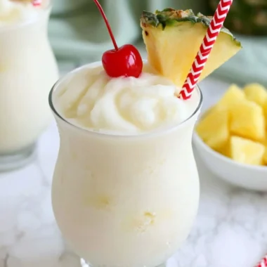 Non-alcoholic virgin piña colada served in a coconut with tropical fruits