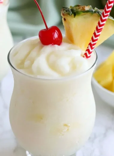 Non-alcoholic virgin piña colada served in a coconut with tropical fruits